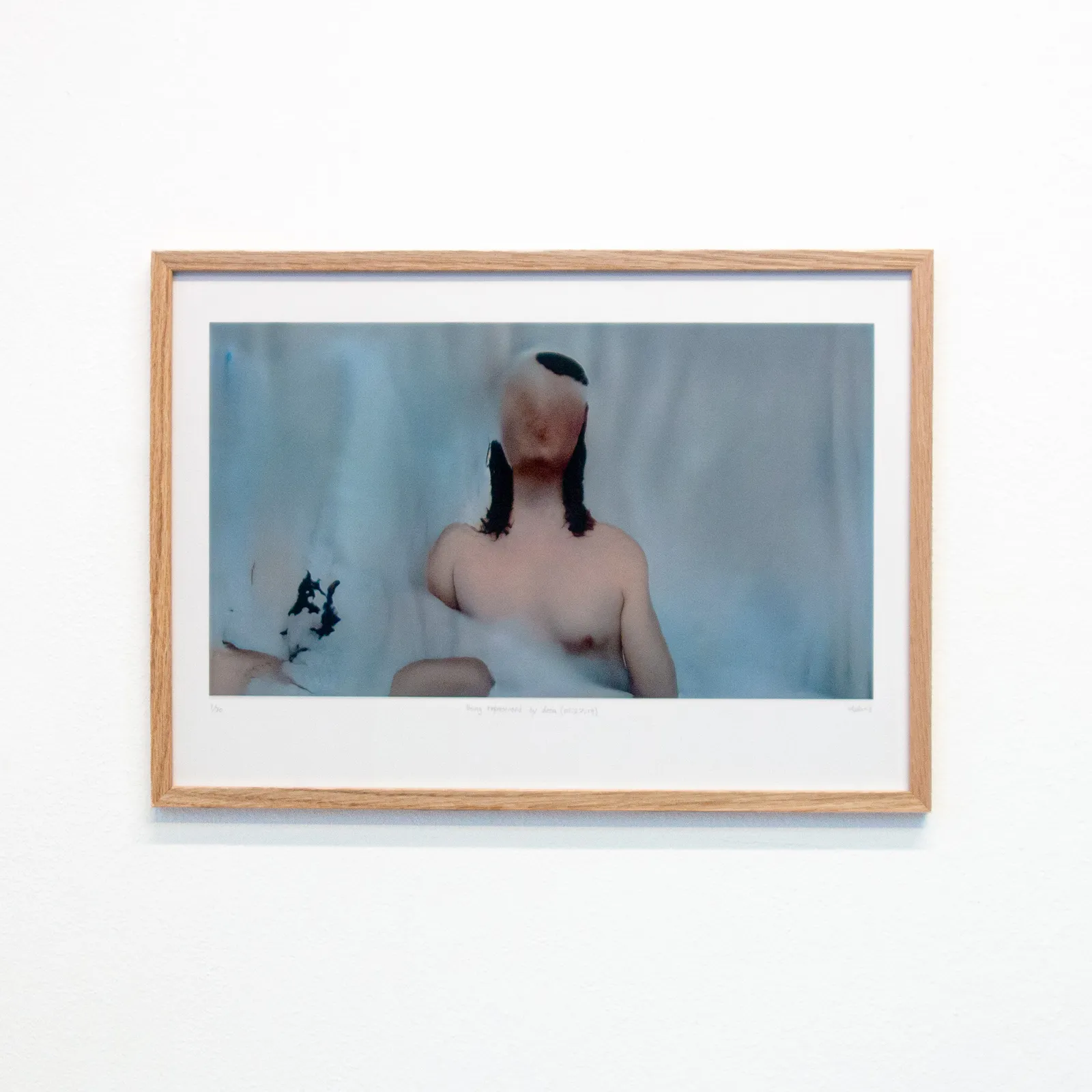 A framed version of a fleshy, glitchy still of "Being represented by data is like losing a part of yourself"