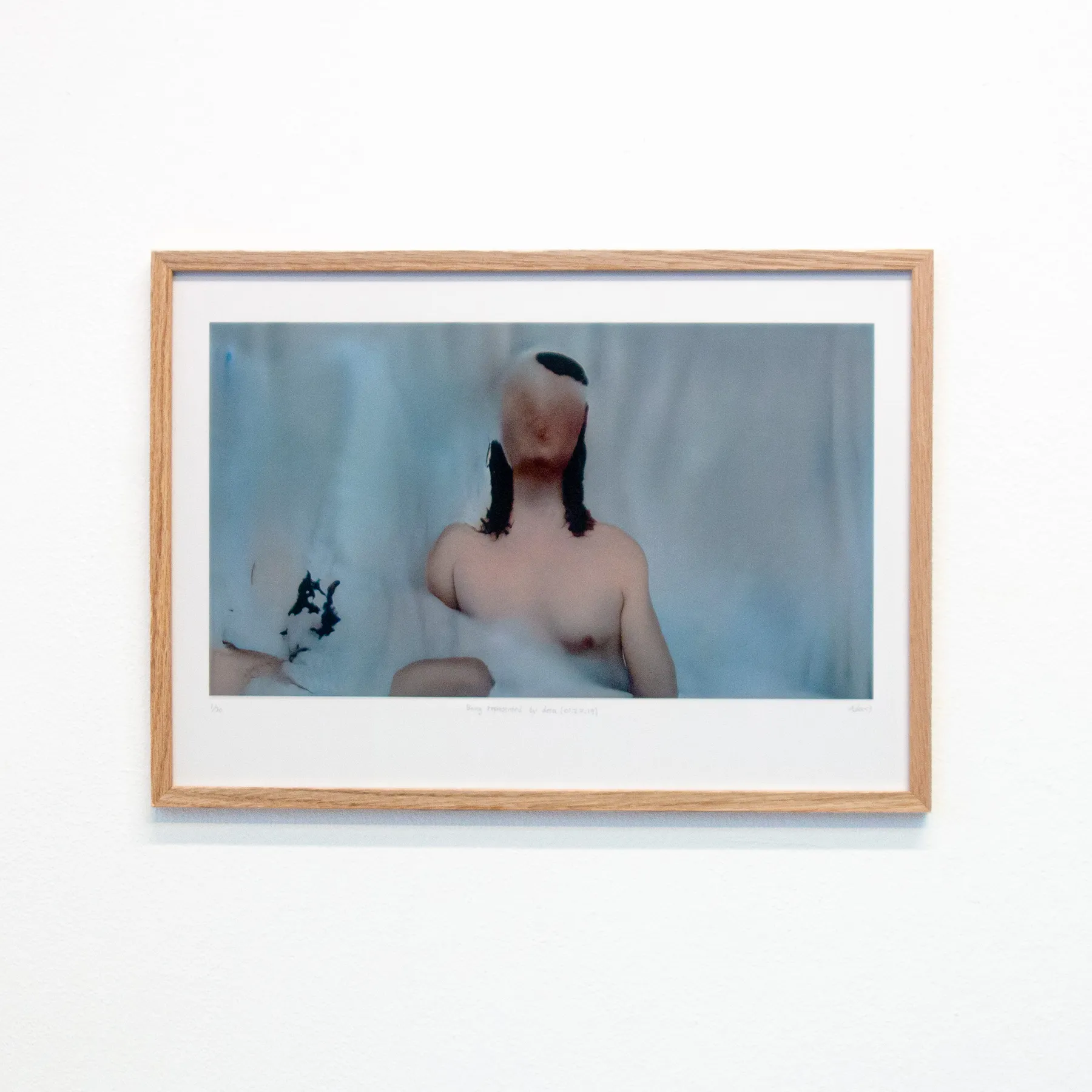 A framed version of a fleshy, glitchy still of "Being represented by data is like losing a part of yourself"