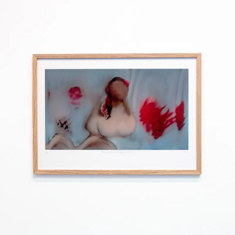 A framed version of a red, glitchy still of "Being represented by data is like losing a part of yourself"